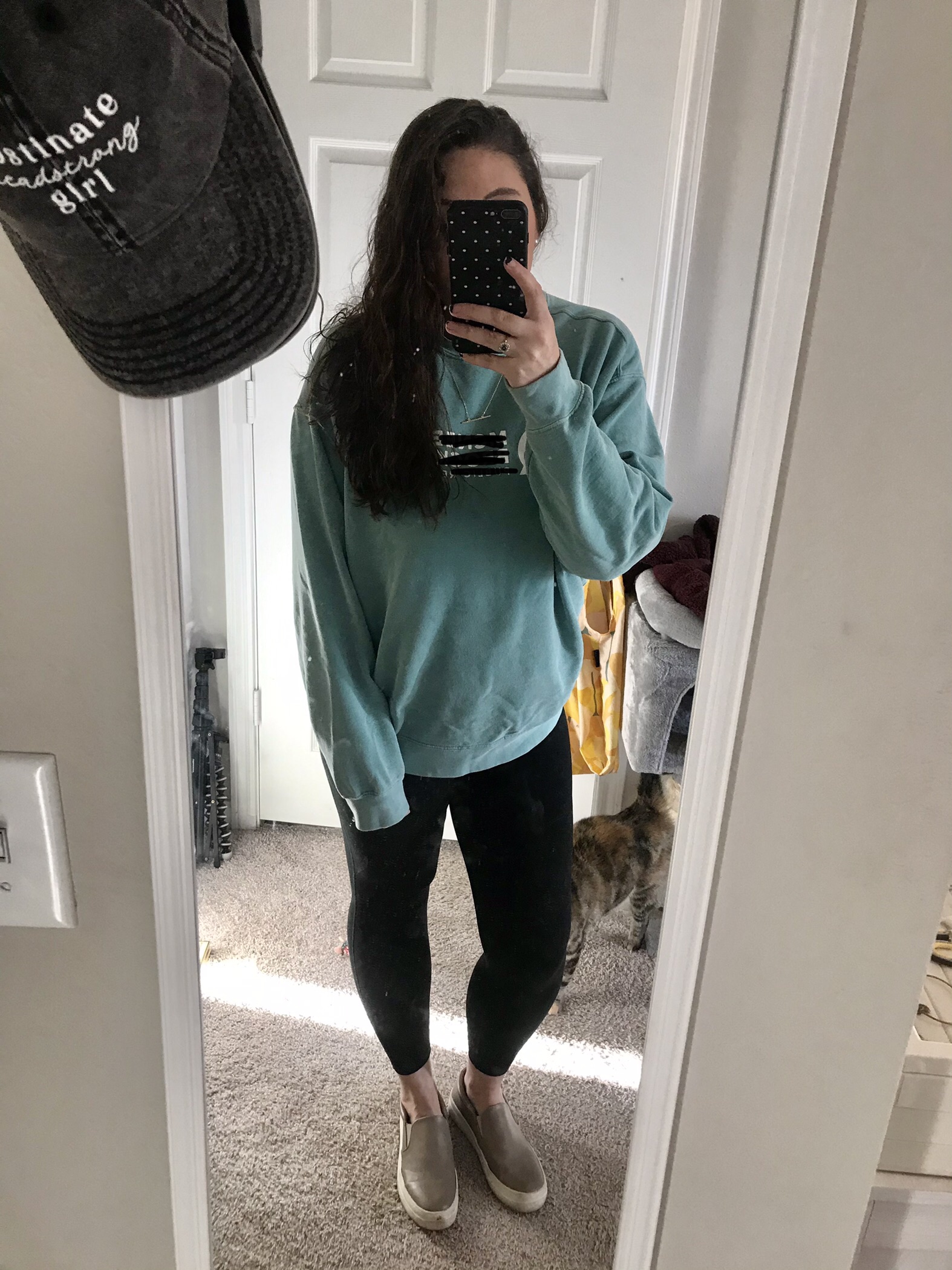 Girl in teal sweatshirt with black leggings