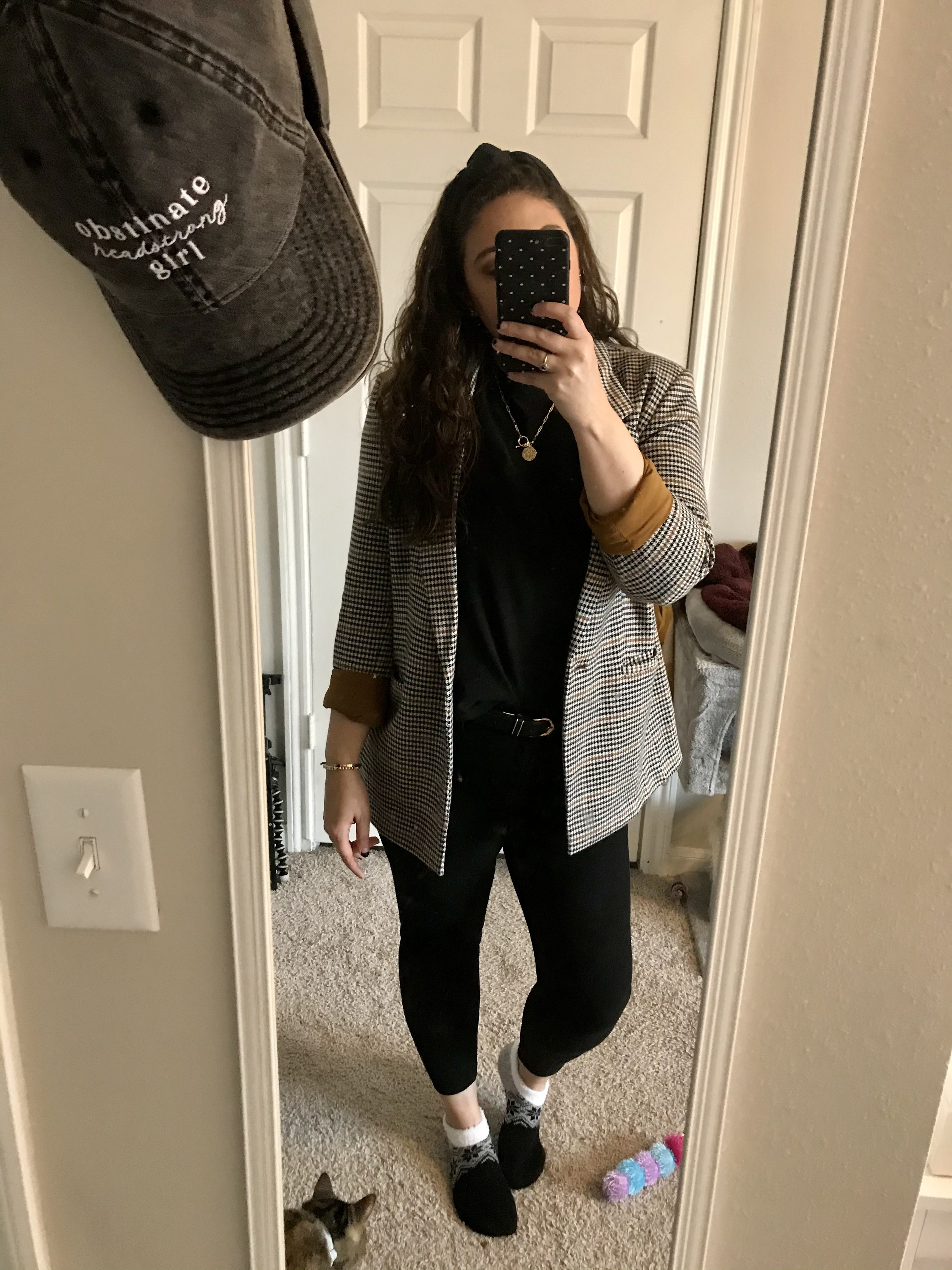girl in black t-shirt, plaid blazer and jeans