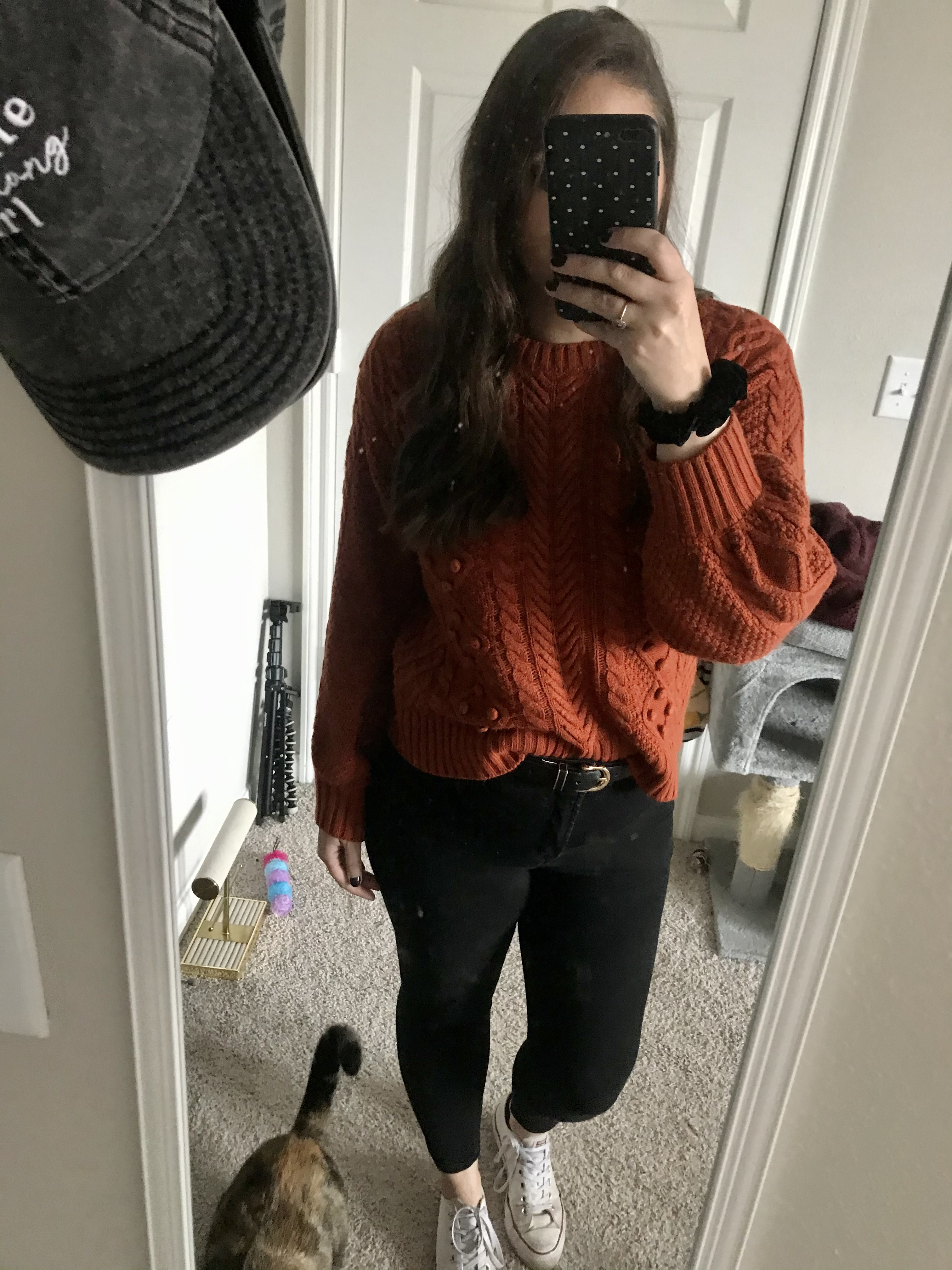 girl in orange sweater and black jeans